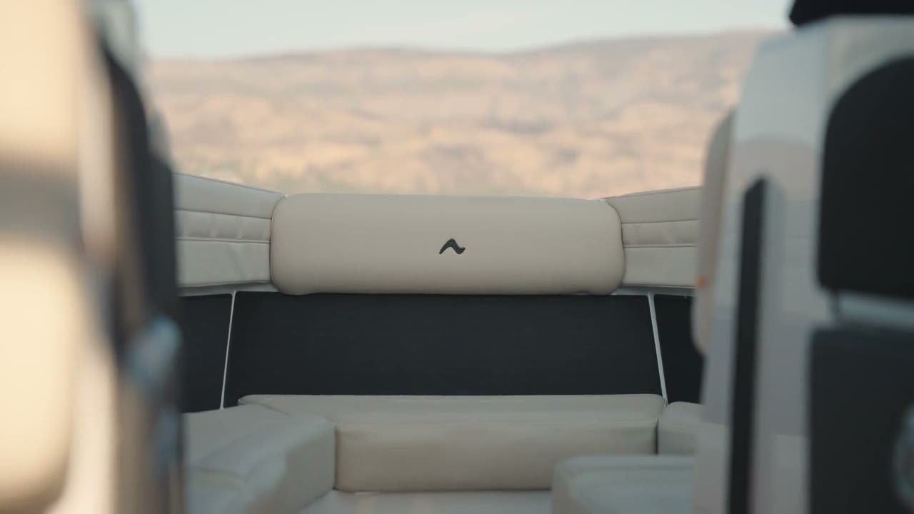 Looking over the stern seats of a boat toward dry hills, a CCX best clip
