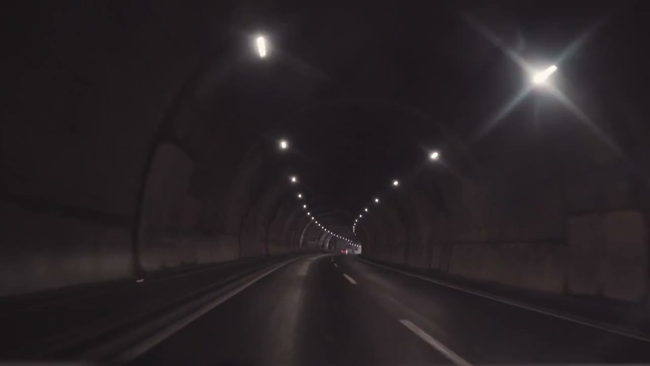 Driving through a lit road tunnel