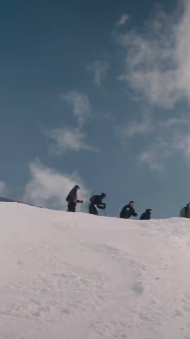 Skiers traversing a high ridge line