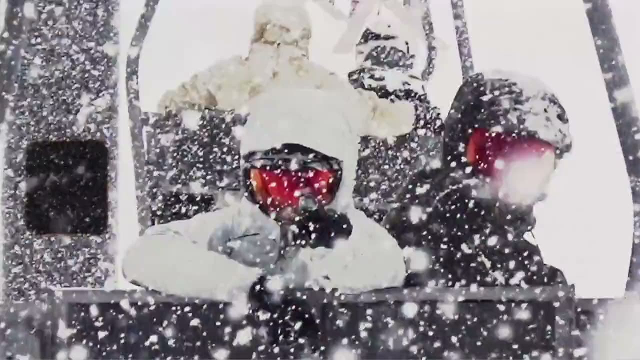 Riders on a snow-covered chairlift