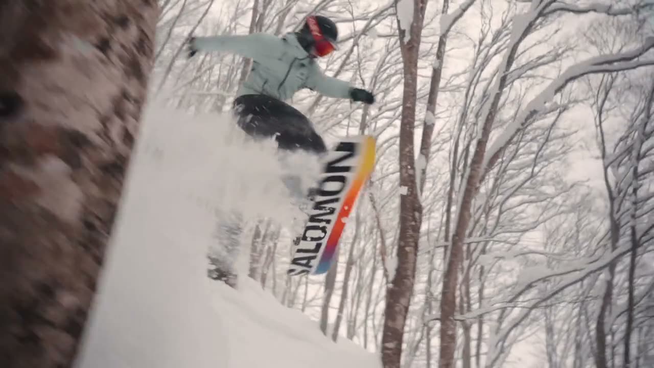 Rider launching through snowy trees