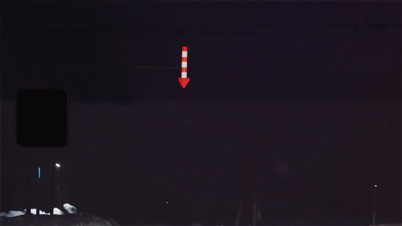 Night road, a lit sign in the dark
